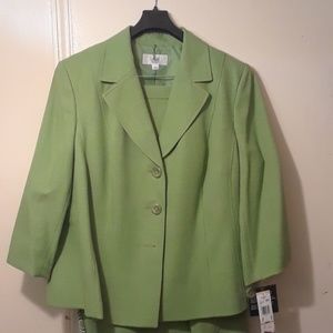 Green skirt and jacket suit with scarf.